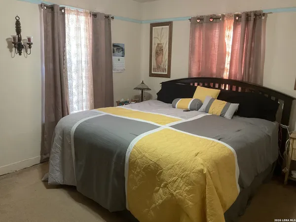 a bedroom with a bed and window