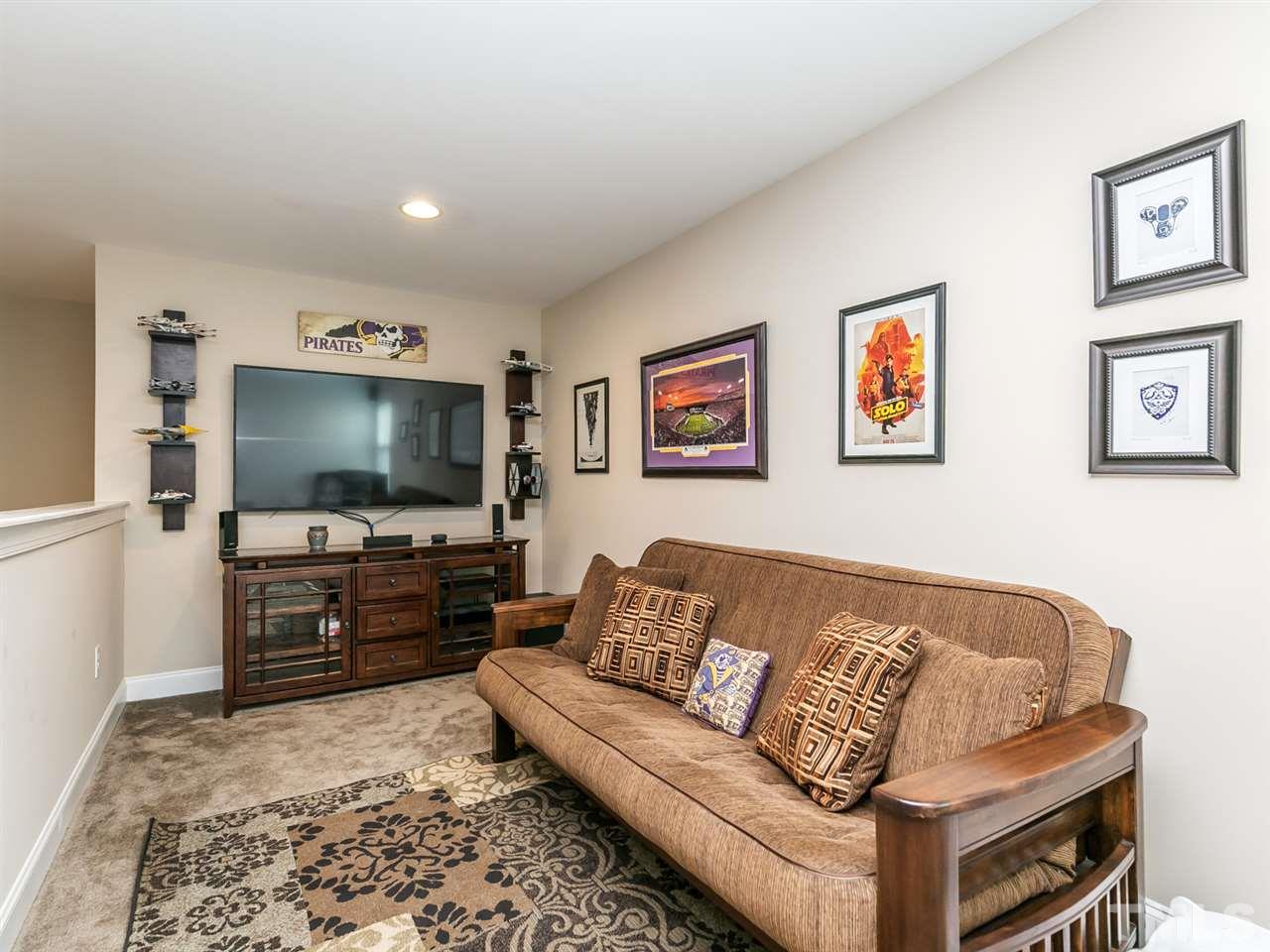 7726 Cedarshire Court Raleigh, NC 27616 - Photo 11 of 28 a living room with furniture and a flat screen tv