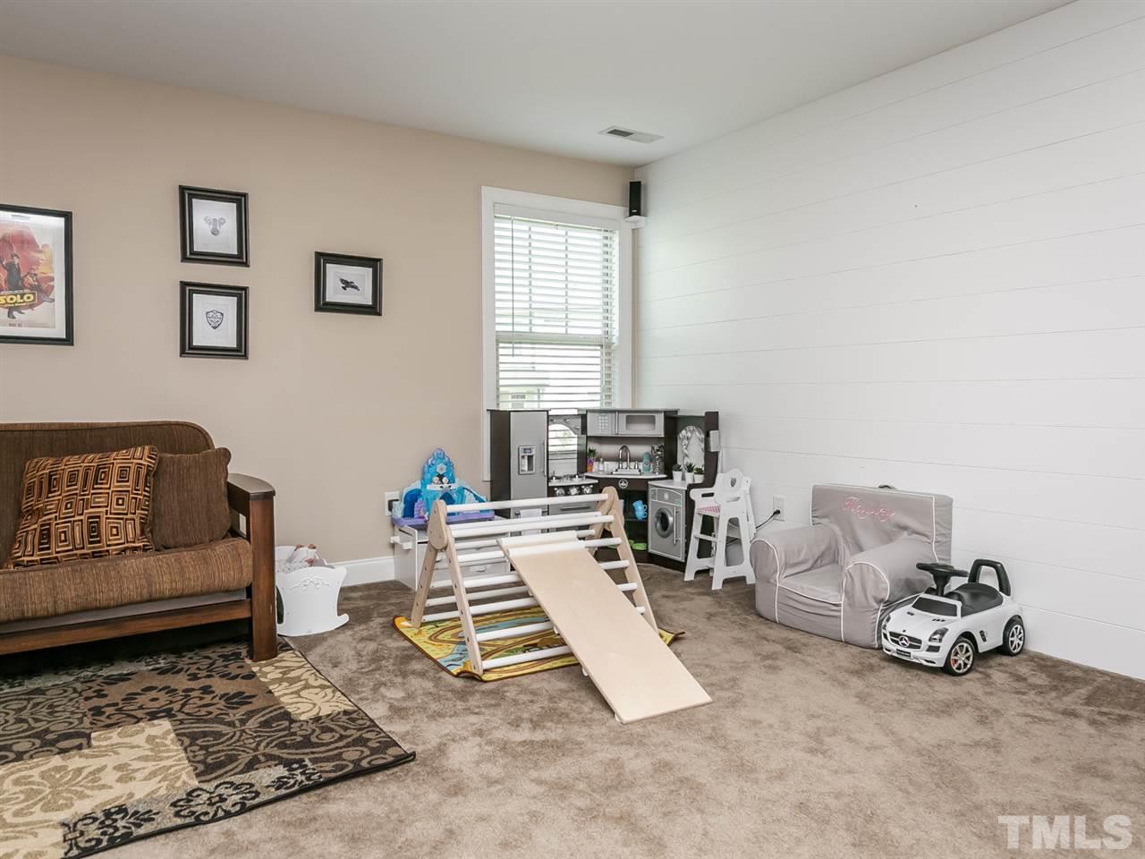 7726 Cedarshire Court Raleigh, NC 27616 - Photo 12 of 28 a living room with furniture a rug and a window