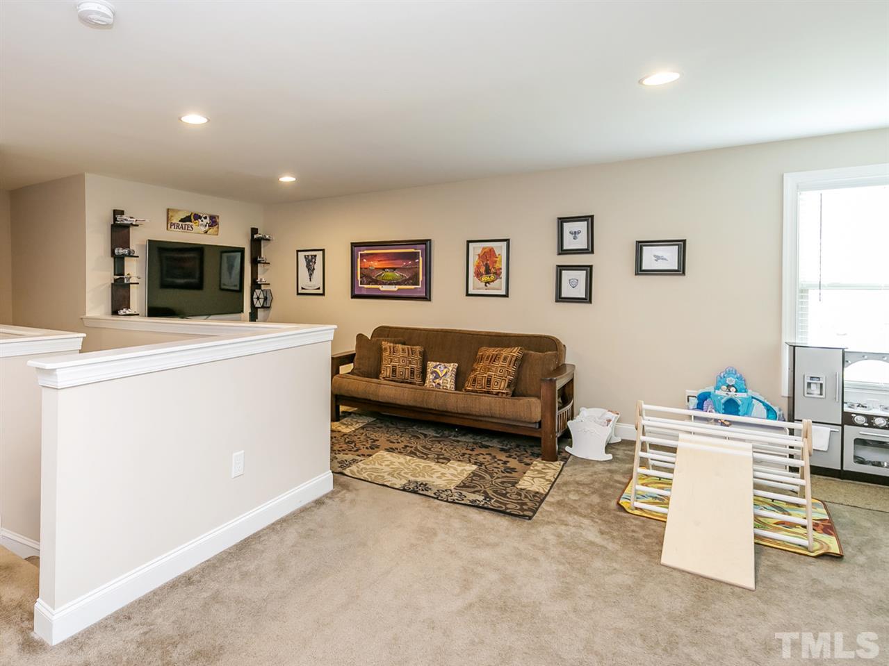 7726 Cedarshire Court Raleigh, NC 27616 - Photo 13 of 28 a living room with furniture and a flat screen tv