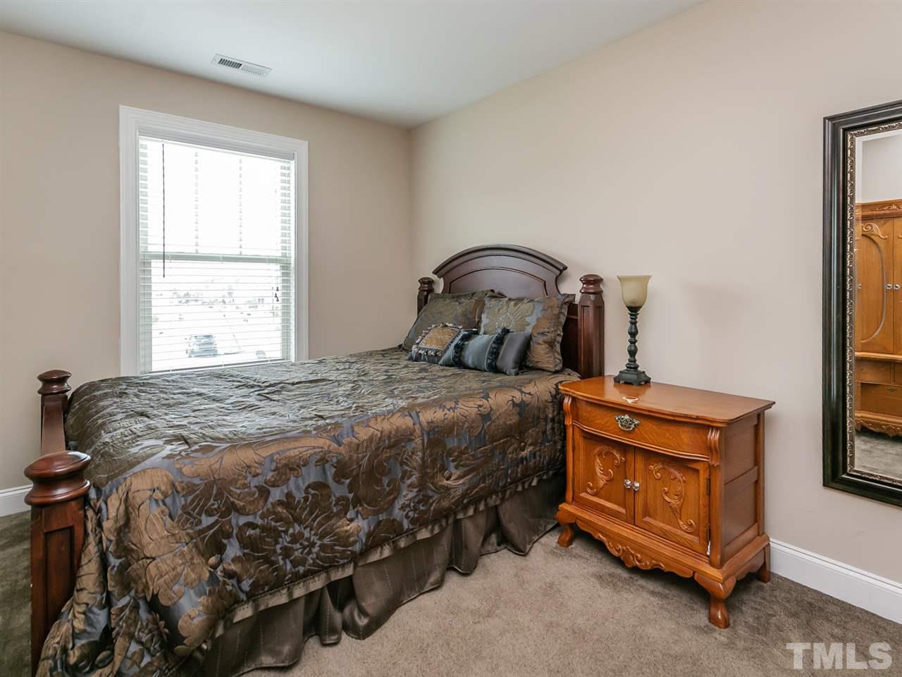 7726 Cedarshire Court Raleigh, NC 27616 - Photo 14 of 28 a bedroom with a bed next to a window