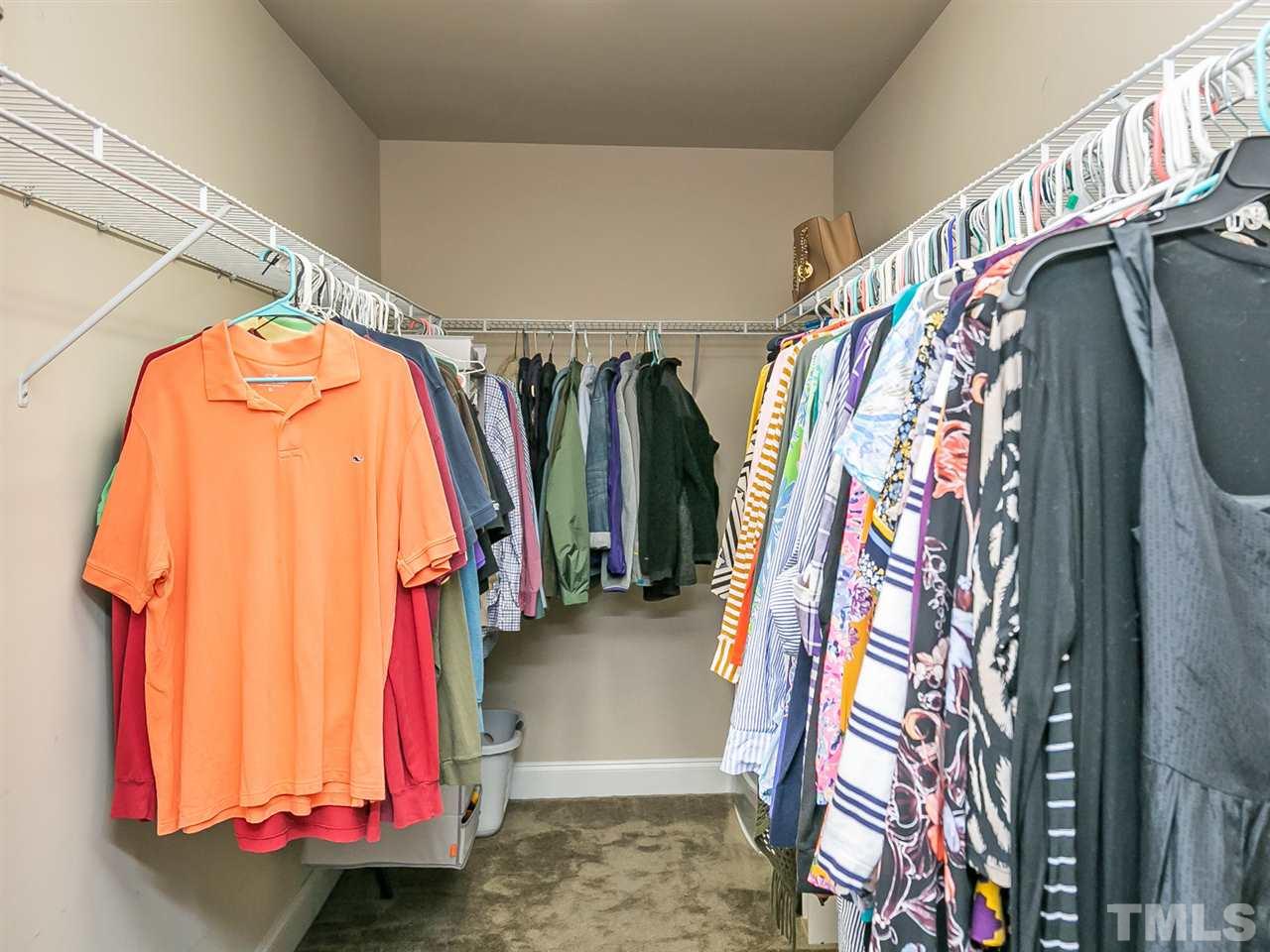 7726 Cedarshire Court Raleigh, NC 27616 - Photo 19 of 28 a view of walk in closet with clothes