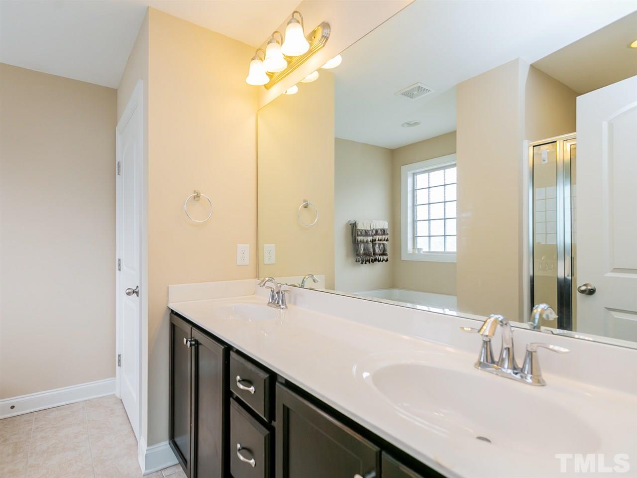 7726 Cedarshire Court Raleigh, NC 27616 - Photo 20 of 28 a bathroom with a sink double vanity and a mirror