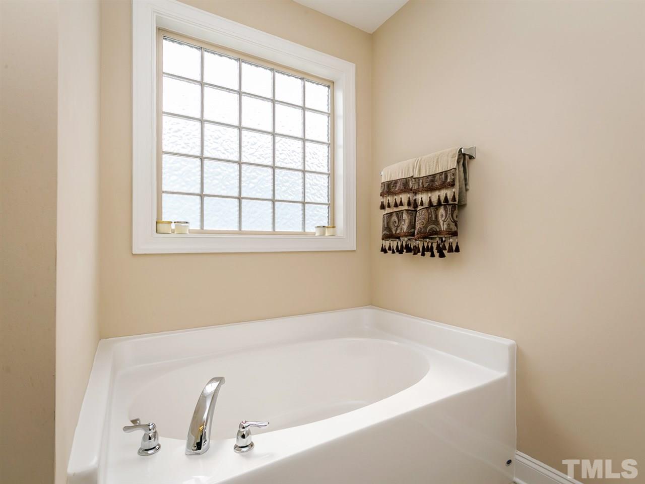 7726 Cedarshire Court Raleigh, NC 27616 - Photo 21 of 28 a bathroom with a bathtub