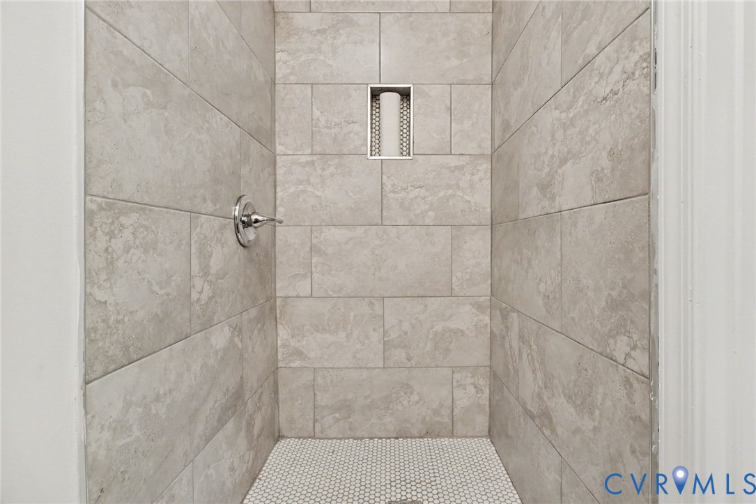 7213 Bennington Road Richmond, VA 23225 - Photo 5 of 24 Shower with light-toned rectangular wall tiling, a
