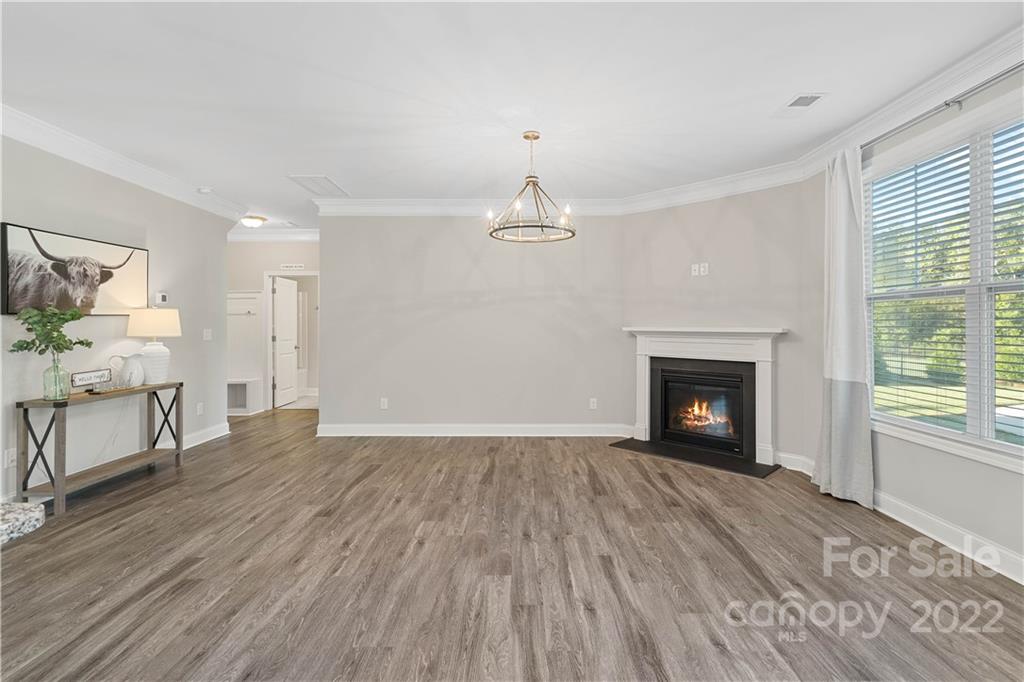 4025 Shadowbrook Road Waxhaw, NC 28173 - Photo 16 of 48 a view of empty room with wooden floor fireplace and windows