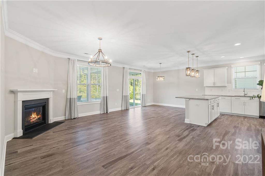 4025 Shadowbrook Road Waxhaw, NC 28173 - Photo 18 of 48 a view of a kitchen with a fireplace wooden floor and windows