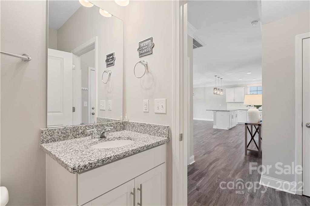 4025 Shadowbrook Road Waxhaw, NC 28173 - Photo 21 of 48 a bathroom with a granite countertop sink a mirror and shower