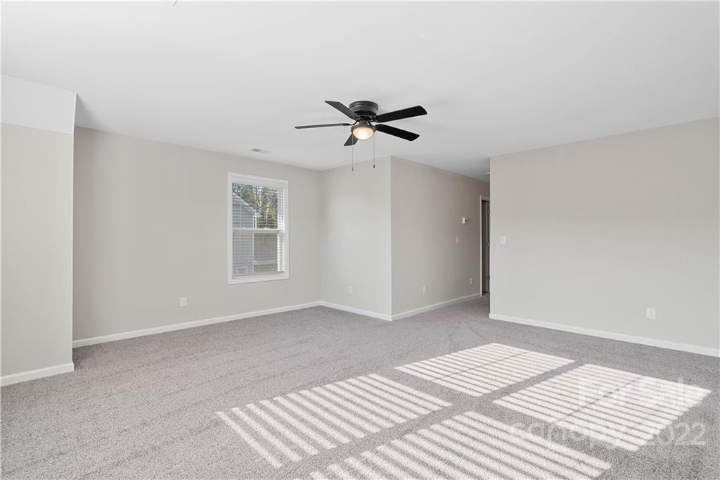 4025 Shadowbrook Road Waxhaw, NC 28173 - Photo 23 of 48 a view of a bedroom with a ceiling fan and a window