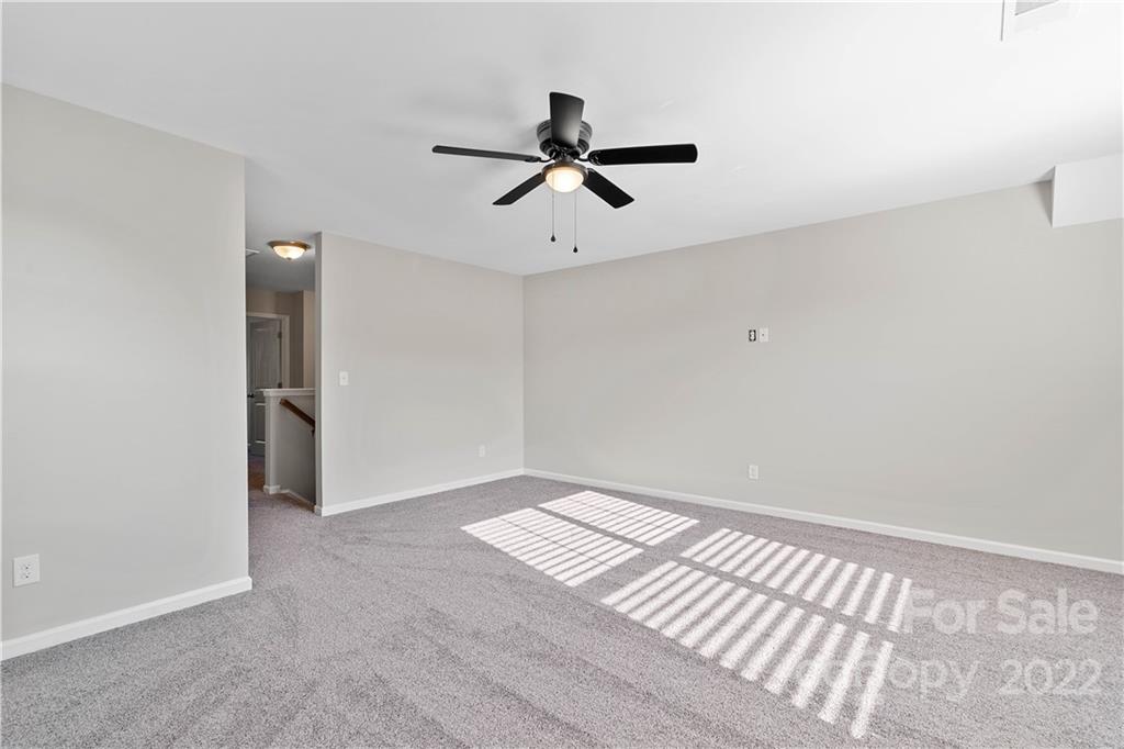 4025 Shadowbrook Road Waxhaw, NC 28173 - Photo 24 of 48 a view of empty room with wooden floor and ceiling fan
