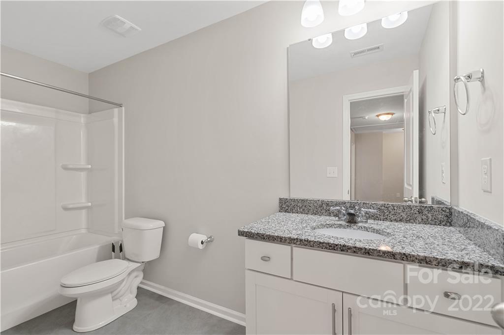 4025 Shadowbrook Road Waxhaw, NC 28173 - Photo 25 of 48 a bathroom with a granite countertop sink a toilet and shower