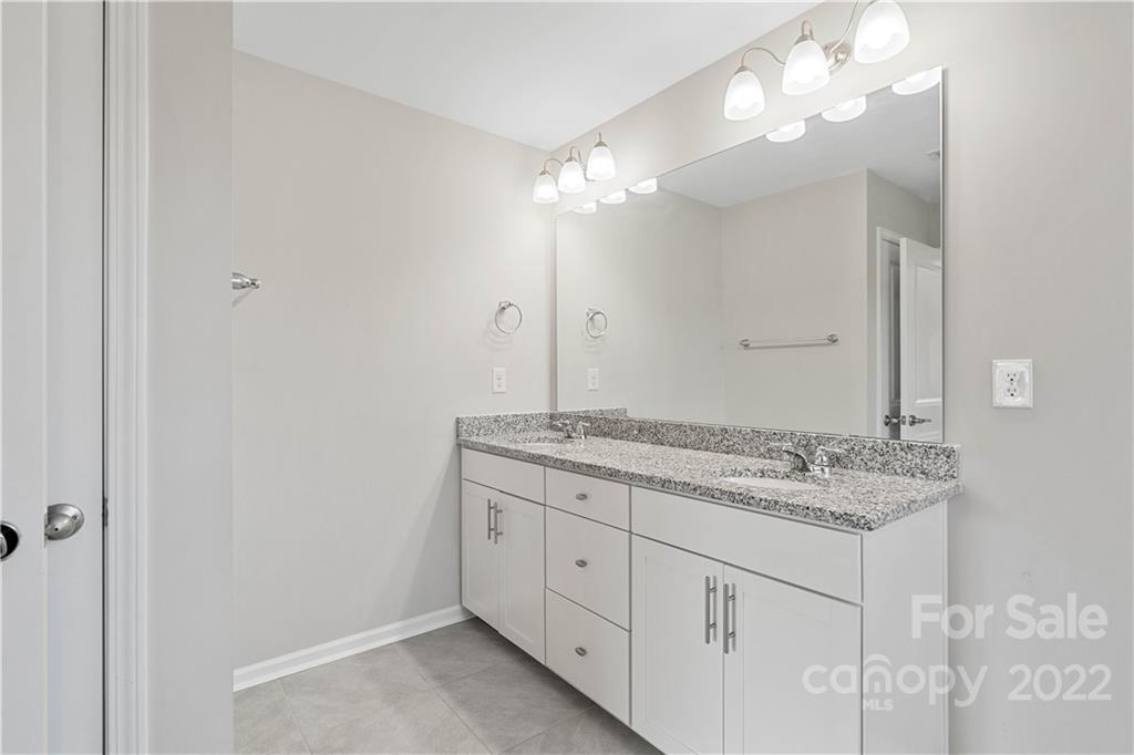 4025 Shadowbrook Road Waxhaw, NC 28173 - Photo 34 of 48 a bathroom with a granite countertop double vanity sink and a mirror