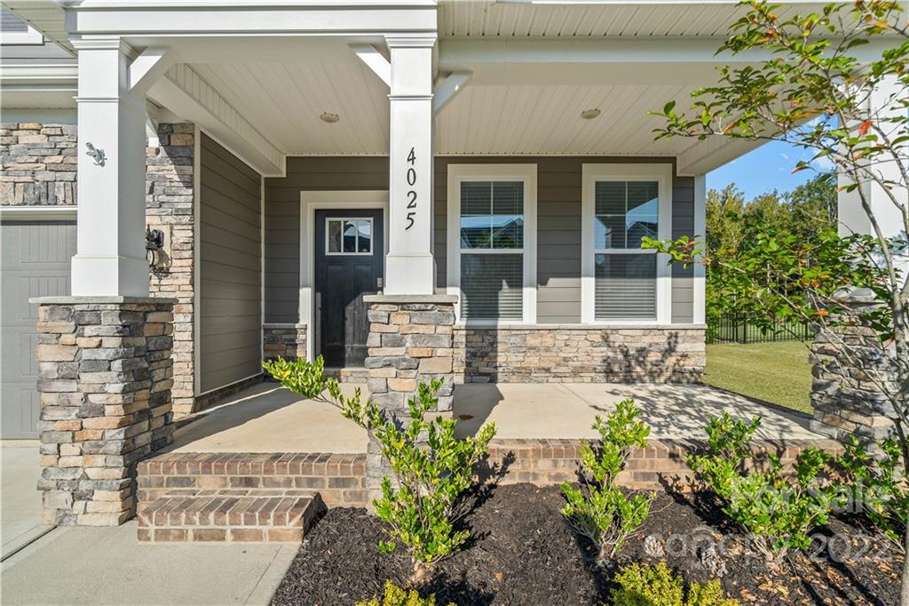 4025 Shadowbrook Road Waxhaw, NC 28173 - Photo 42 of 48 a front view of a house with a garden