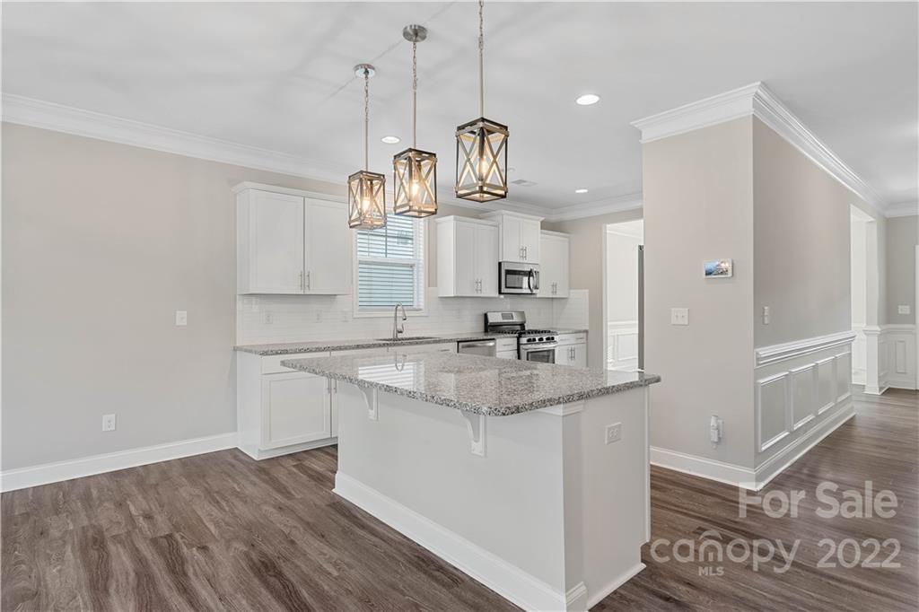 4025 Shadowbrook Road Waxhaw, NC 28173 - Photo 10 of 48 a kitchen with stainless steel appliances granite countertop a sink a refrigerator and a granite counter tops