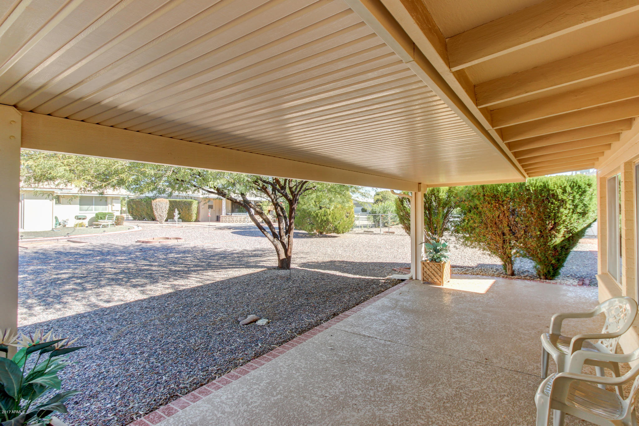 10008 West Riviera Drive Sun City, AZ 85351 - Photo 5 of 26 a view of a backyard with a large tree