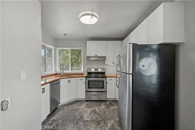 a kitchen with a refrigerator and a stove