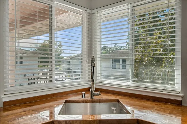 a view of a kitchen with a sink and dining table