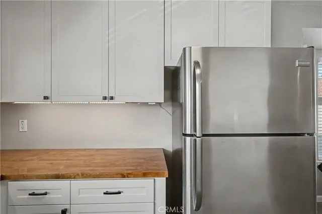 a view of cabinets with refrigerator