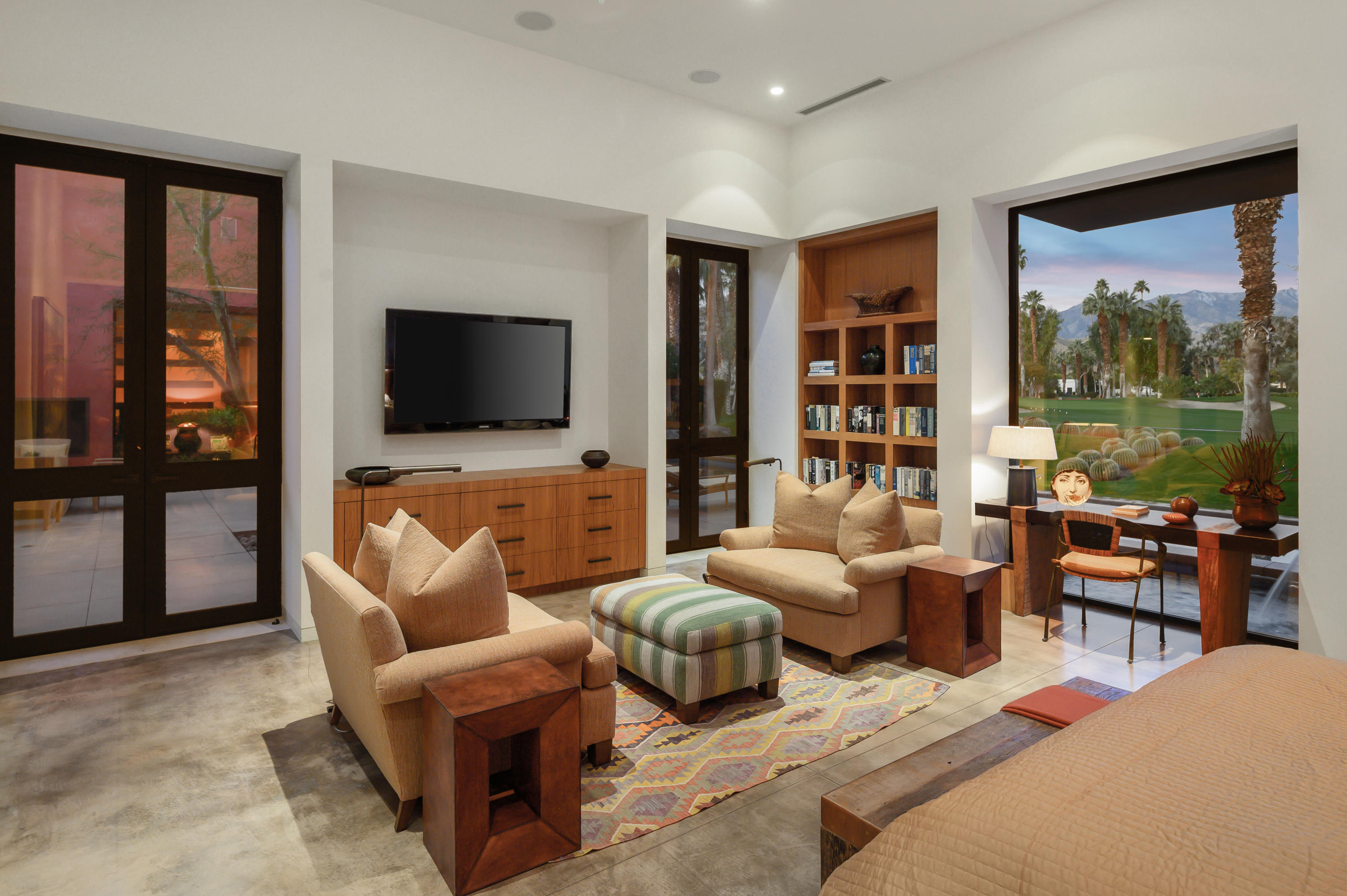 37801 Thompson Road Rancho Mirage, CA 92270 - Photo 19 of 31 a living room with furniture a flat screen tv and a floor to ceiling window