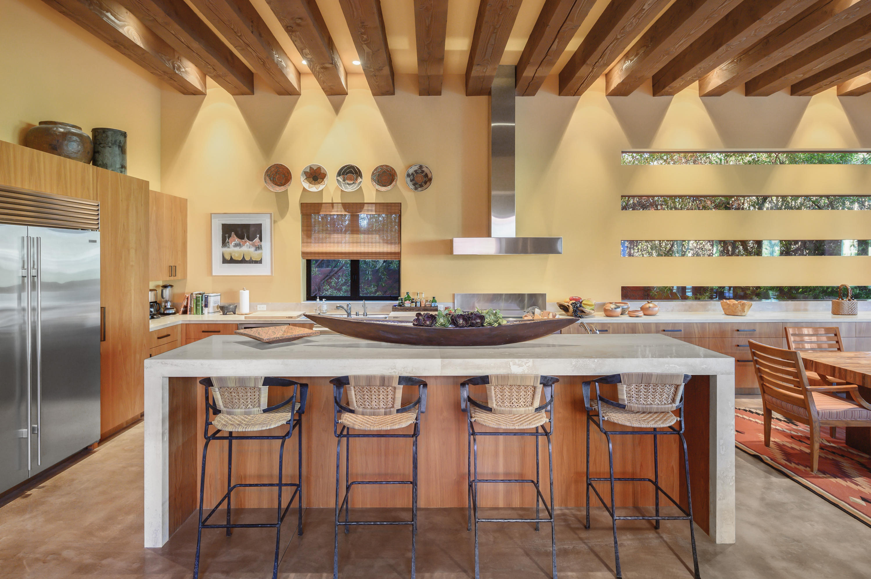 37801 Thompson Road Rancho Mirage, CA 92270 - Photo 21 of 31 a kitchen with stainless steel appliances granite countertop a table chairs stove and large window