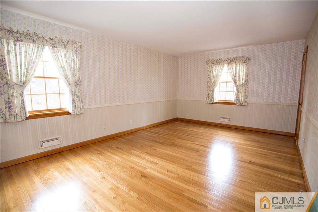 103 Buchanan Road Edison, NJ 08820 - Photo 13 of 25 a view of empty room with wooden floor and fan