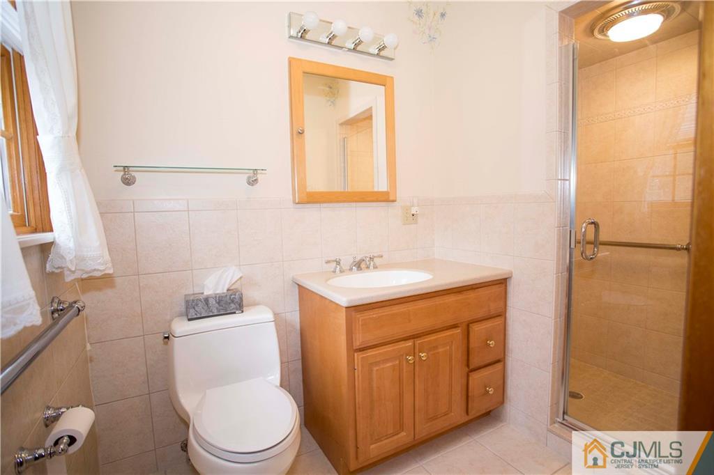 103 Buchanan Road Edison, NJ 08820 - Photo 15 of 25 a bathroom with a toilet sink and mirror