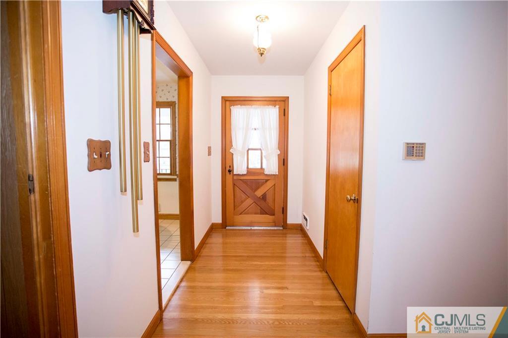 103 Buchanan Road Edison, NJ 08820 - Photo 18 of 25 a view of a hallway with wooden floor and staircase