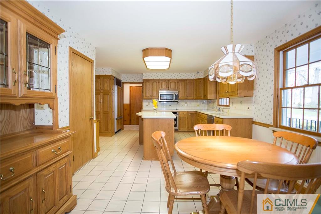 103 Buchanan Road Edison, NJ 08820 - Photo 4 of 25 a large kitchen with a table and chairs