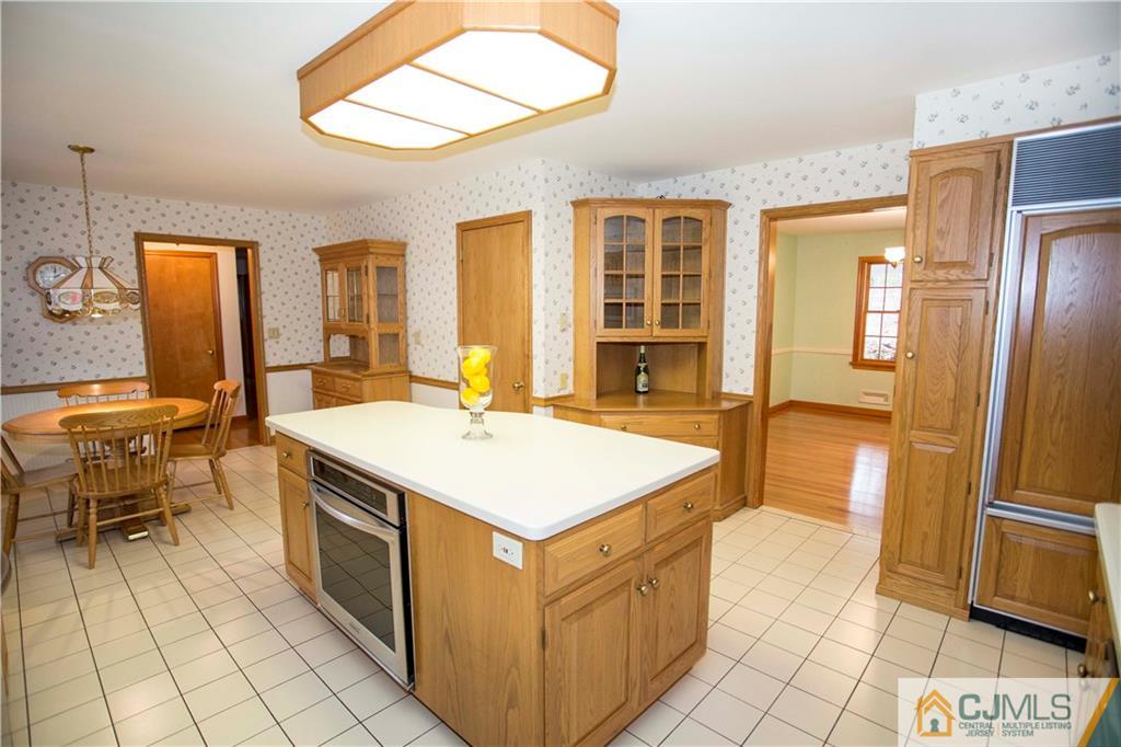 103 Buchanan Road Edison, NJ 08820 - Photo 5 of 25 a kitchen with stainless steel appliances a stove a sink and a refrigerator