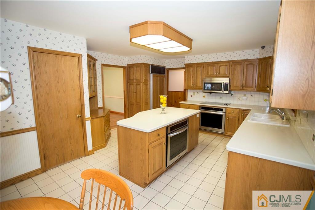 103 Buchanan Road Edison, NJ 08820 - Photo 6 of 25 a kitchen with a stove a sink and a refrigerator