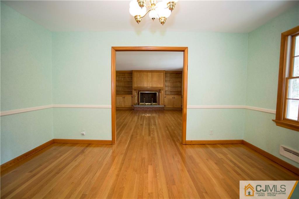 103 Buchanan Road Edison, NJ 08820 - Photo 8 of 25 a view of a room with wooden floor and a ceiling fan