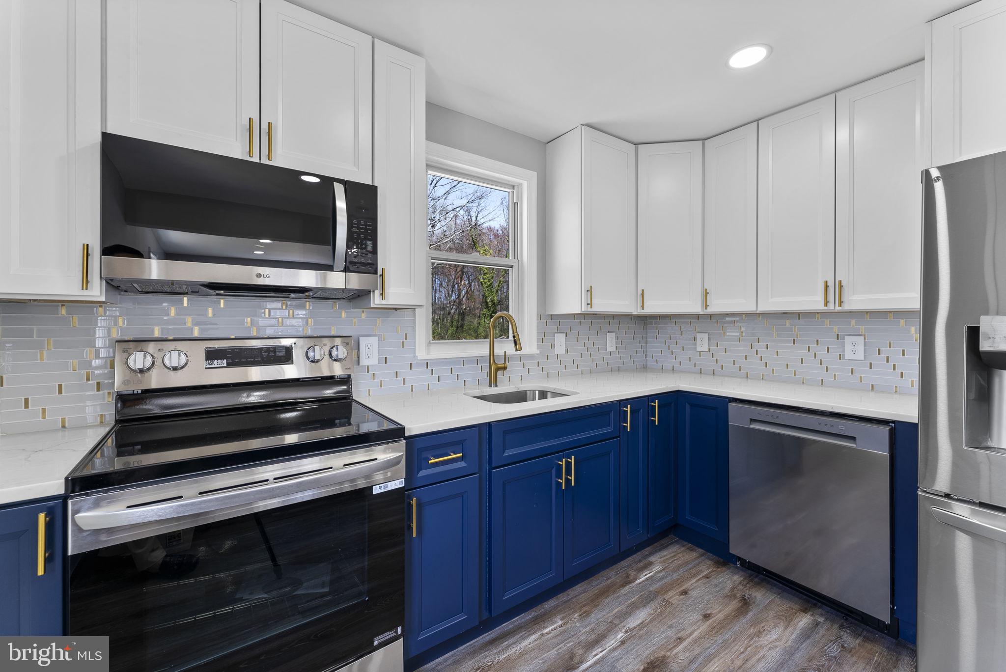 8310 Karl Avenue Rosedale, MD 21237 - Photo 13 of 39 a kitchen with stainless steel appliances a stove a microwave and sink