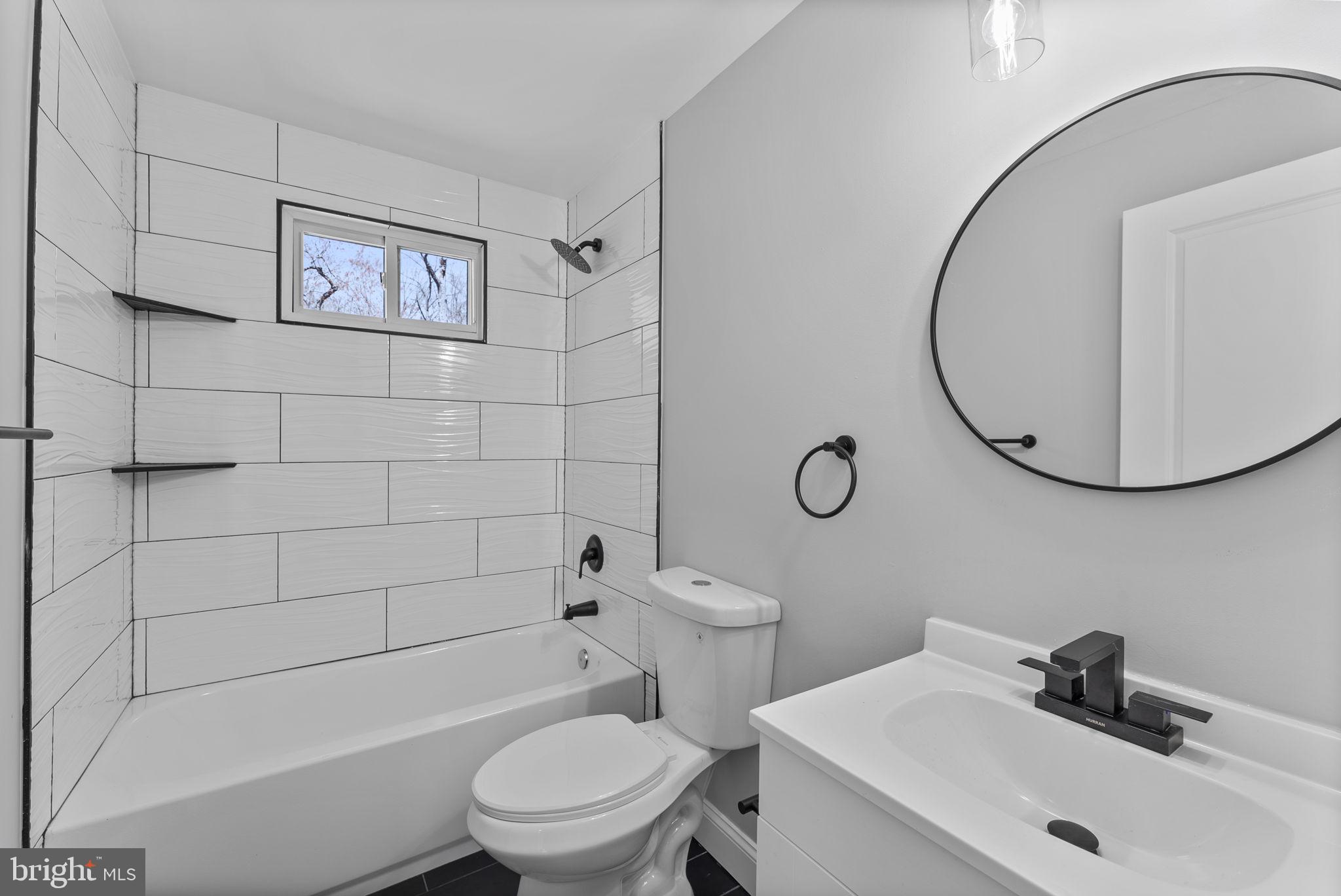 8310 Karl Avenue Rosedale, MD 21237 - Photo 17 of 39 a bathroom with a sink a toilet and shower