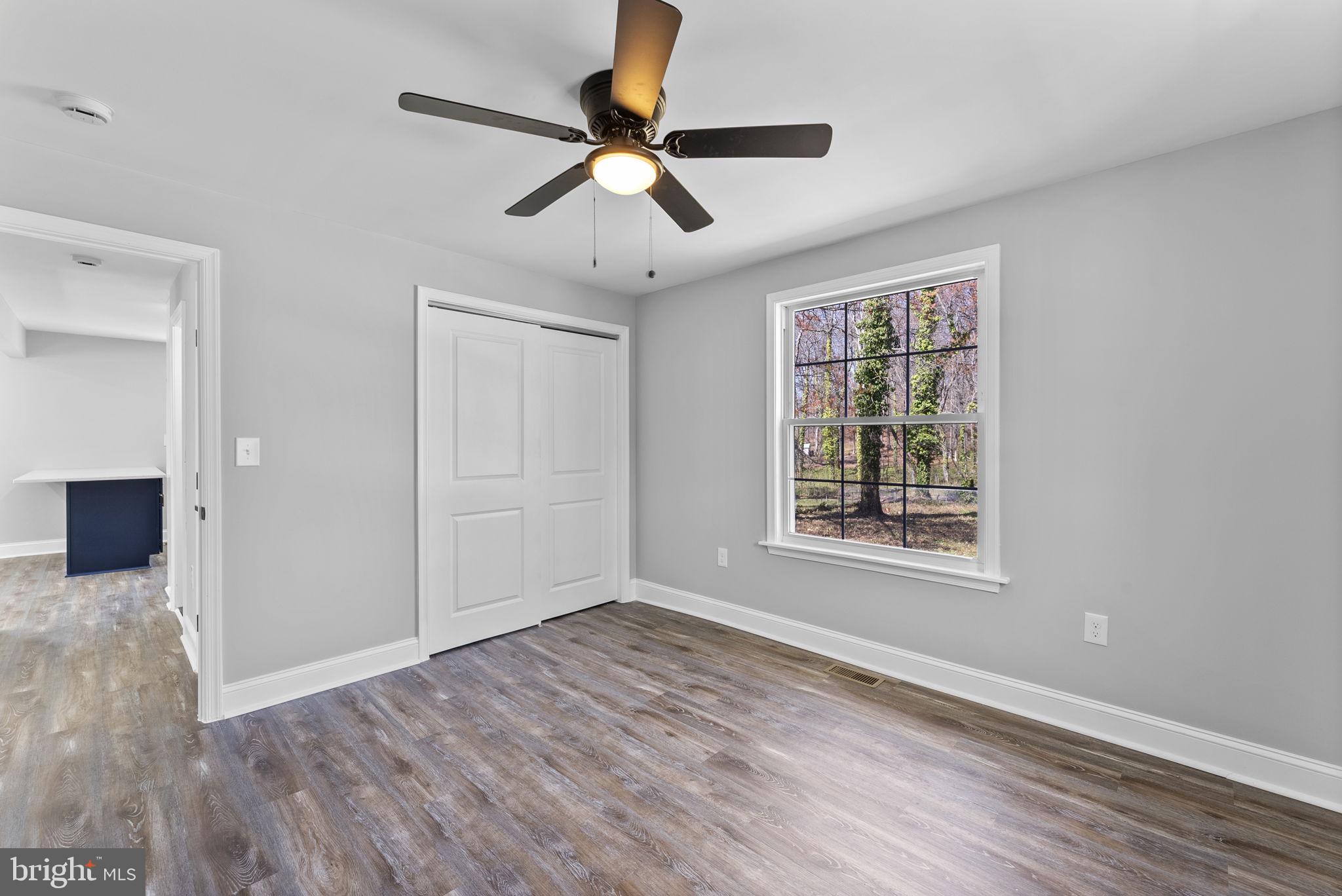 8310 Karl Avenue Rosedale, MD 21237 - Photo 20 of 39 a view of an empty room with wooden floor and a window