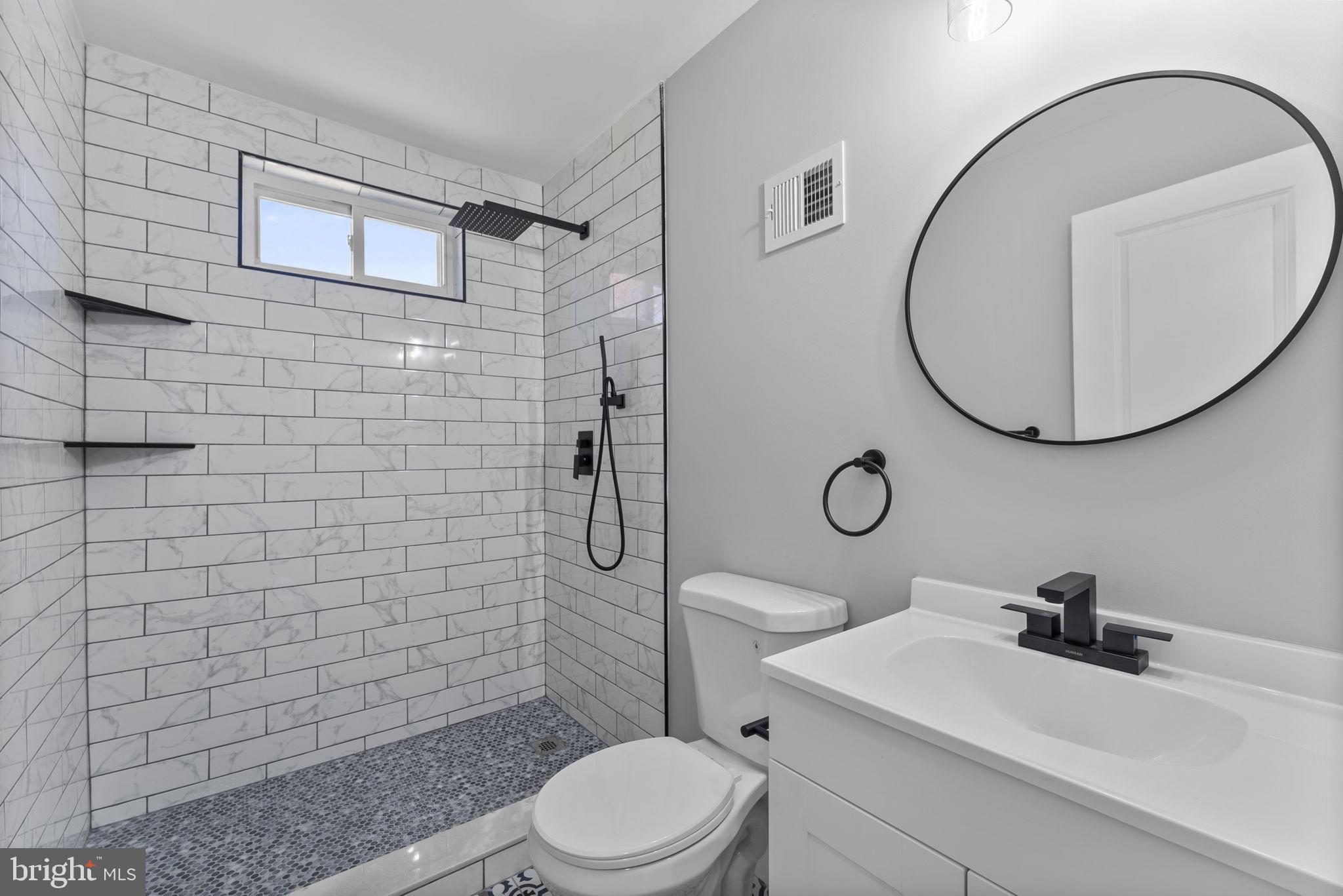 8310 Karl Avenue Rosedale, MD 21237 - Photo 23 of 39 a bathroom with a sink a toilet and shower
