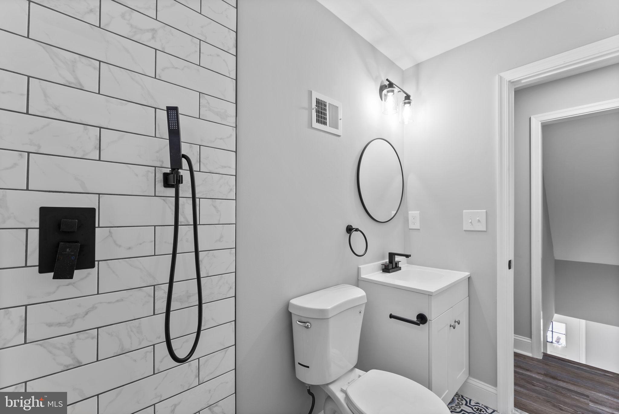 8310 Karl Avenue Rosedale, MD 21237 - Photo 25 of 39 a bathroom with a toilet sink and mirror