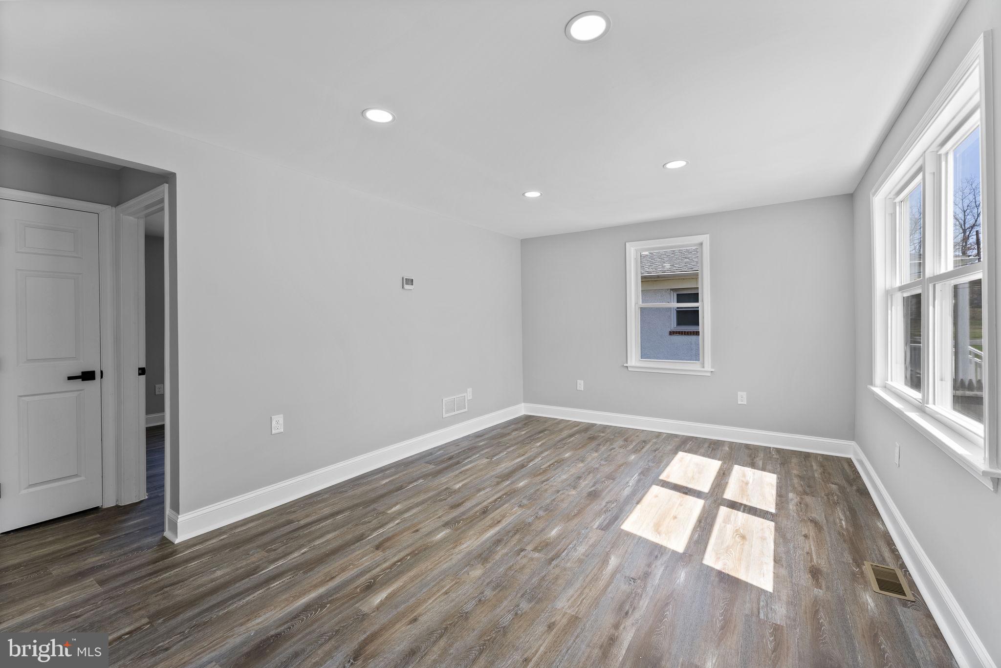 8310 Karl Avenue Rosedale, MD 21237 - Photo 7 of 39 wooden floor in an empty room with a window
