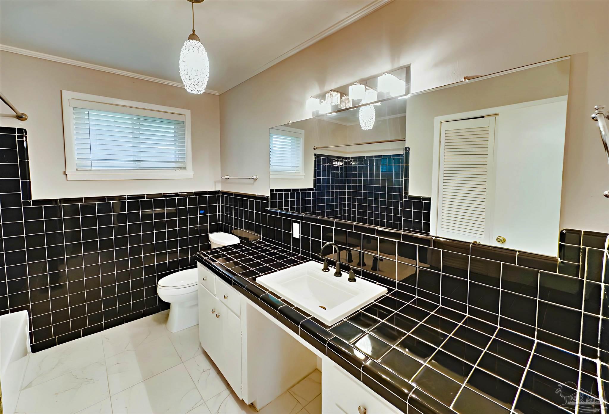 3224 Highway 4 Jay, FL 32565 - Photo 17 of 25 a bathroom with a sink a toilet a mirror and shower