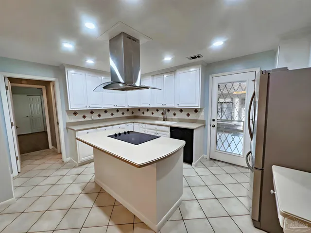a kitchen with a stove cabinets and refrigerator