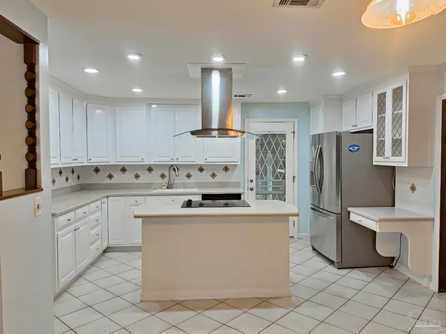 a kitchen with stainless steel appliances granite countertop a sink and a refrigerator