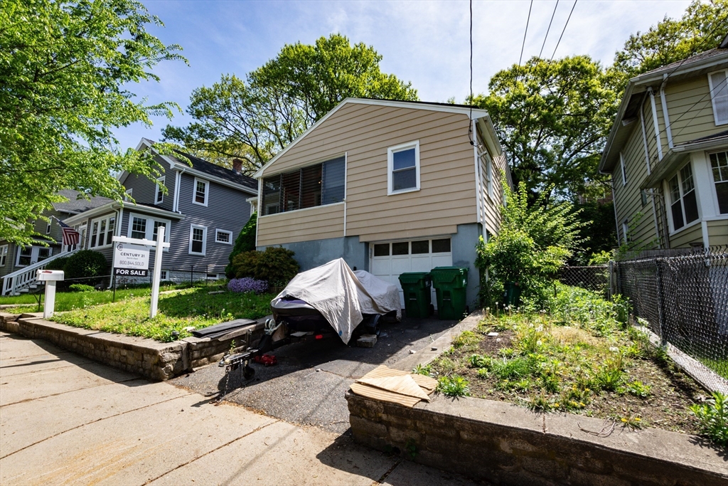 65 Fern Road Medford, MA 02155 - Photo 3 of 32 a front view of a house with garden