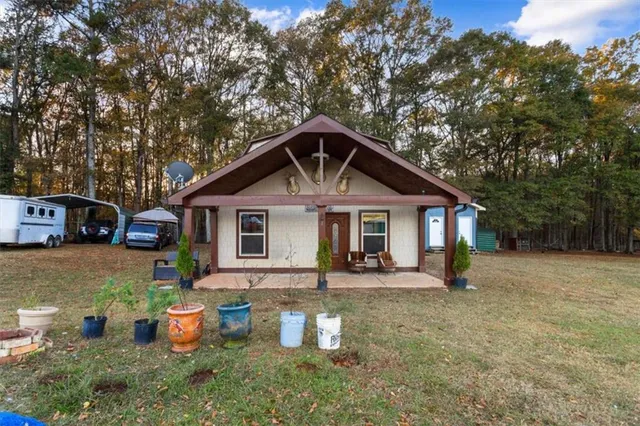 a front view of a house with sitting area