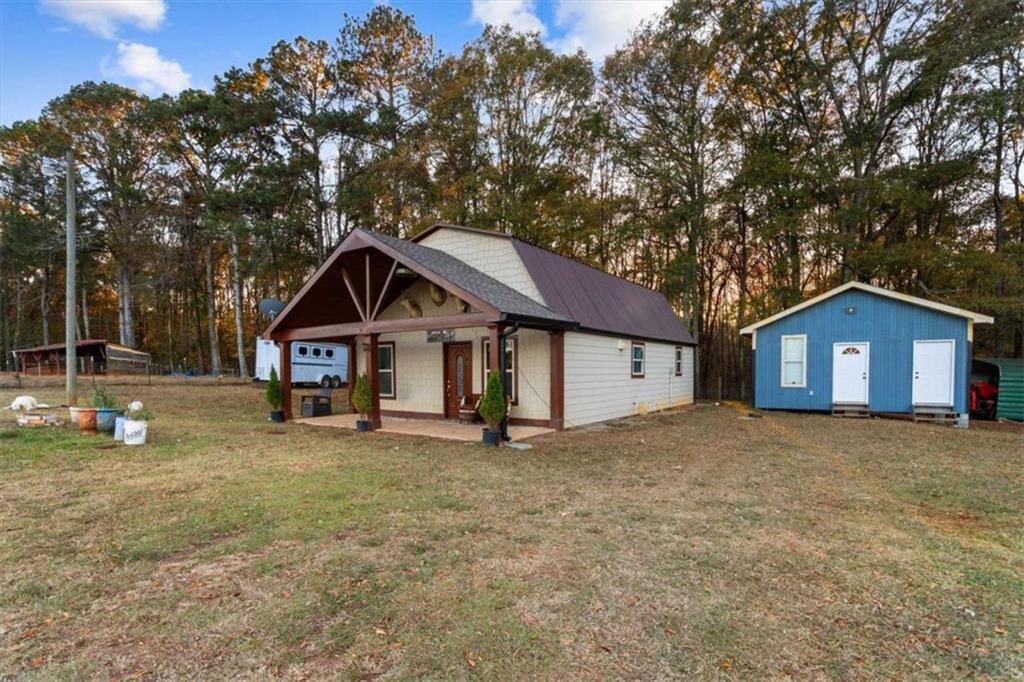 1740 Gratis Road Monroe, GA 30656 - Photo 2 of 26 a house with trees in front of it