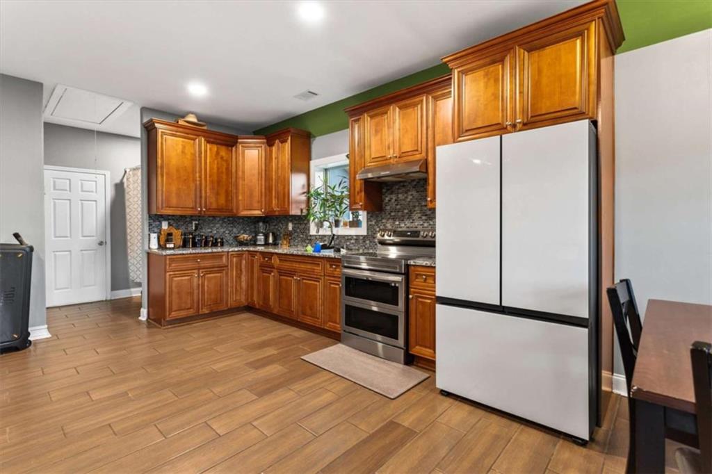 1740 Gratis Road Monroe, GA 30656 - Photo 10 of 26 a kitchen with stainless steel appliances a refrigerator sink and cabinets