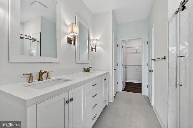 a spacious bathroom with double sink and a mirror