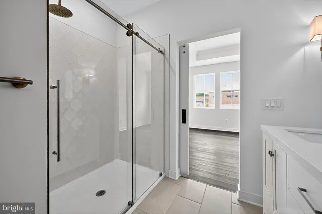 a bathroom with a shower and a sink