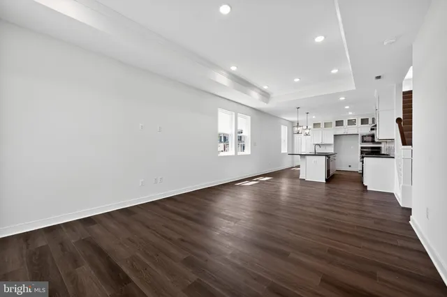 a view of kitchen and hall with wooden floor