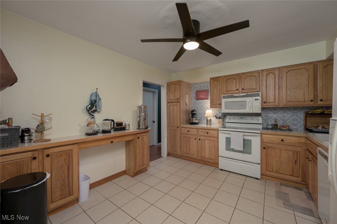 1177 Munroe Falls Kent Road Kent, OH 44240 - Photo 32 of 47 Kitchen featuring ceiling fan, light ceramic tile flooring, backsplash, and white appliances