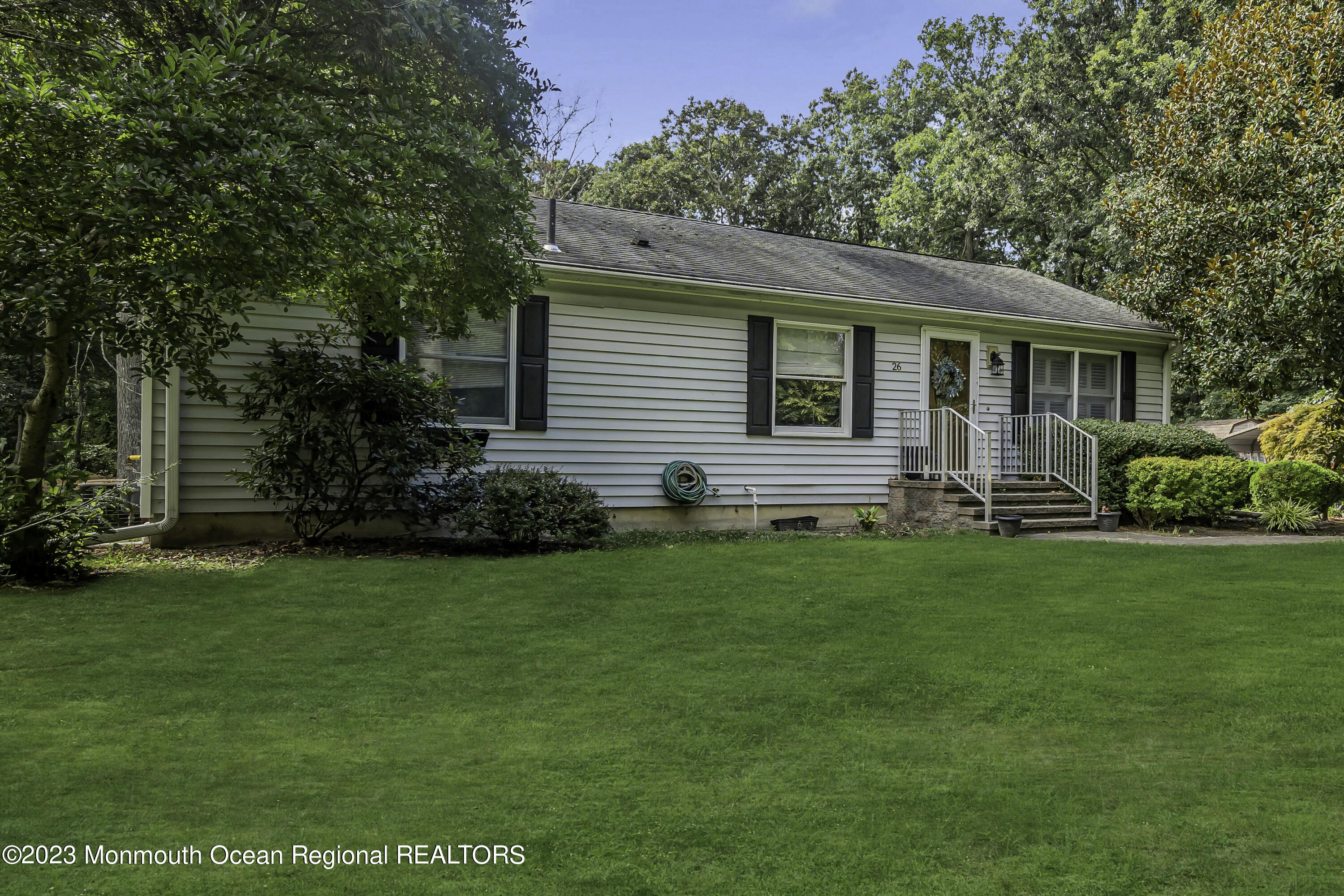 a front view of house with yard and green space