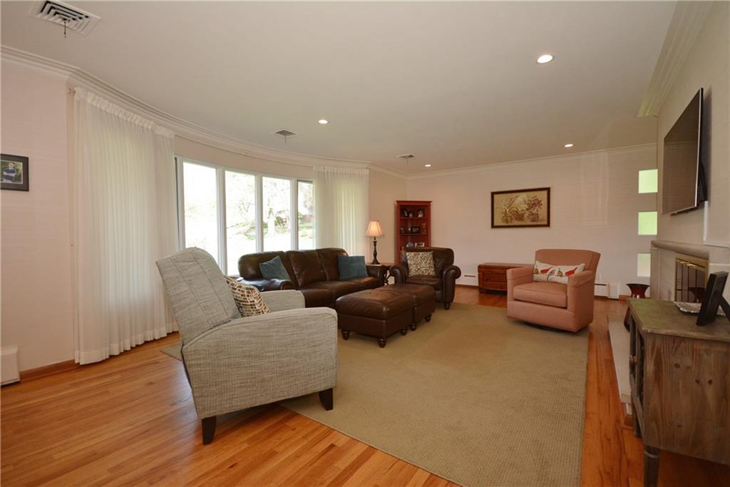 1745 Partridge Run Road Pittsburgh, PA 15241 - Photo 3 of 25 Bright and sunlit, this spacious living room will become the perfect spot for entertaining or relaxing around the fireplace. Crisp and clean with painted walls topped with crowning molding!